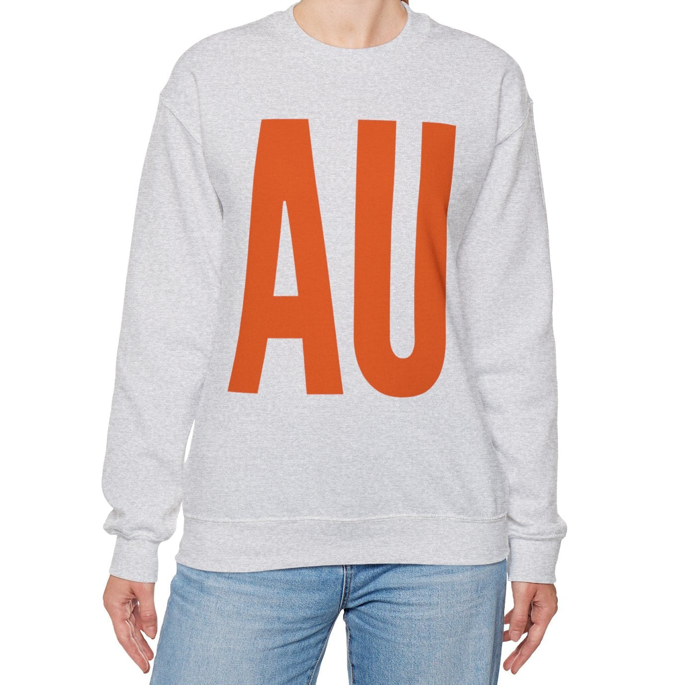 Woman wearing a gray sweatshirt with 'AU' in orange on a white background